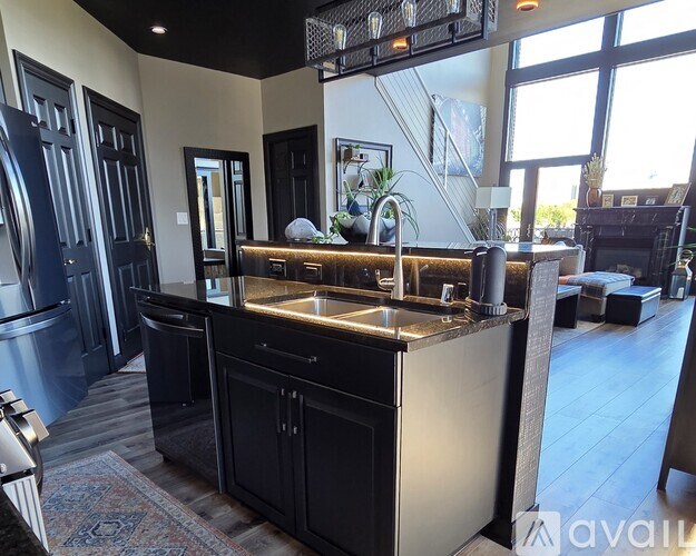 A modern kitchen with a large island and stainless steel appliances.