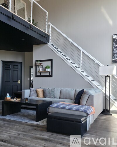A living room with a grey couch and a coffee table.