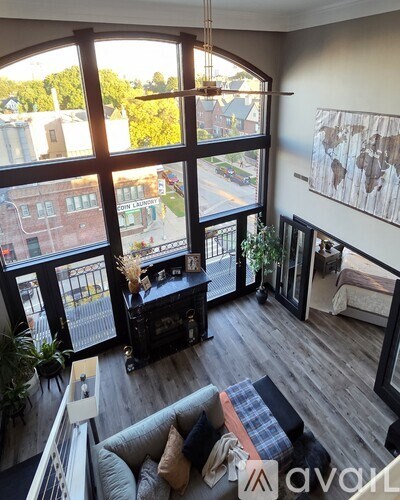 A living room with a grey couch and a wooden floor.