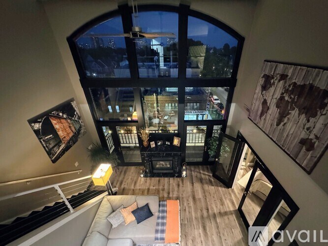 A living room with a couch and a coffee table in front of a large window.