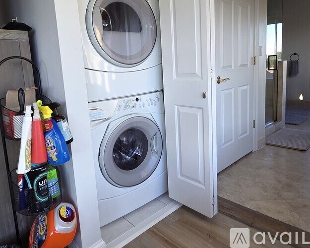 A washing machine is in a small laundry room.