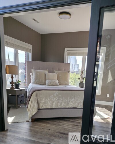A bedroom with a large bed and a window.