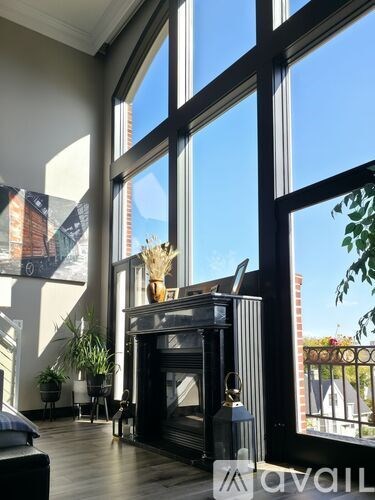 A living room with a fireplace and a large window.