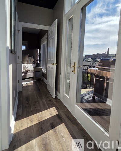 A balcony with a view of the water and buildings outside.