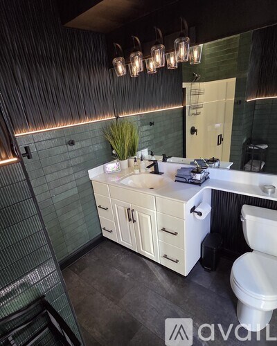 A bathroom with a white sink and a white toilet.