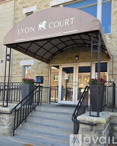 The entrance to the Lyon Court Condominiums building with a covered staircase.