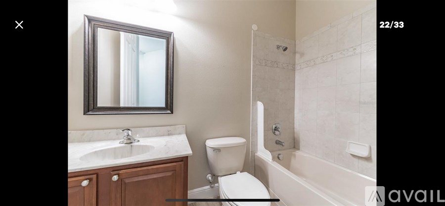 A bathroom with a toilet, sink, and bathtub.