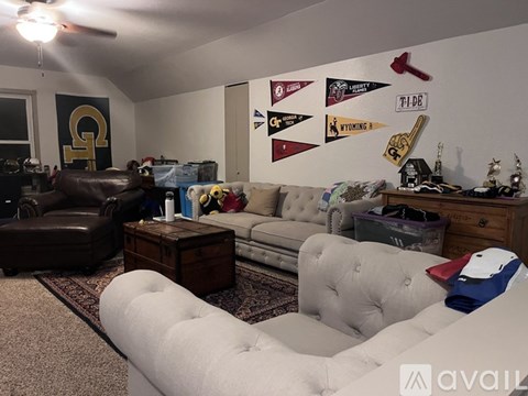 A living room with a white couch and a ceiling fan.