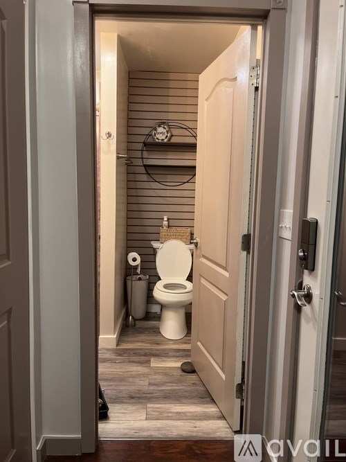 A bathroom with a toilet and a towel rack.