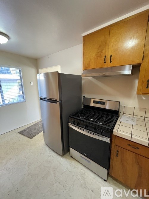 A kitchen with a stainless steel refrigerator, oven, and stove.