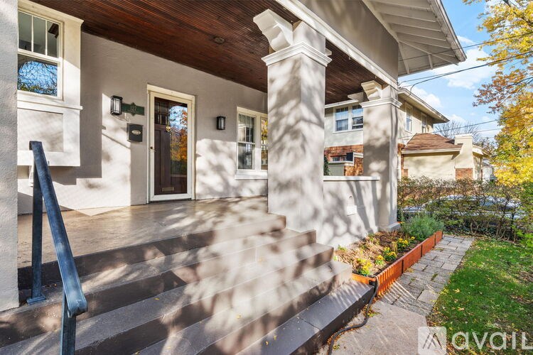 A house with a porch and a front yard.
