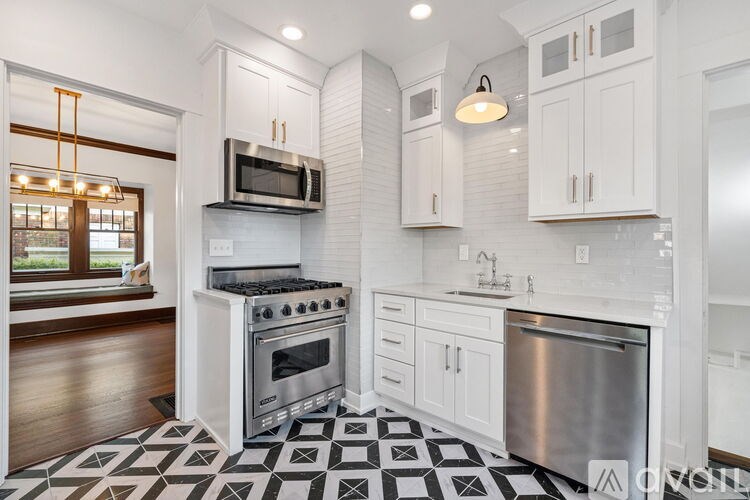 A modern kitchen with a black and white checkered floor.