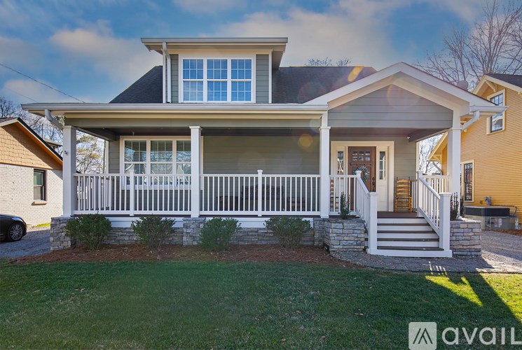 A house with a front porch and a garage door.