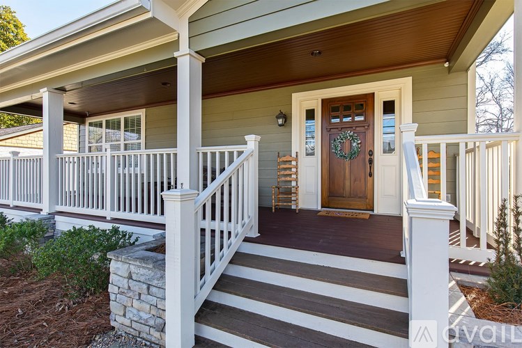 A house with a porch and a wreath on the door.