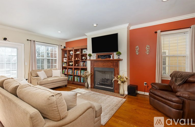 A living room with a fireplace and a television.