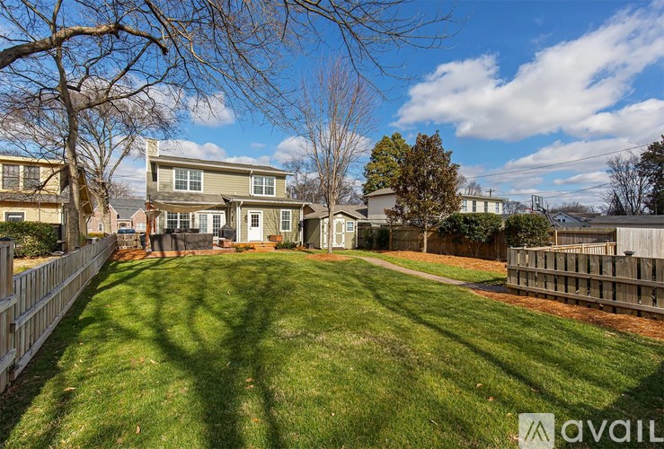 A backyard with a lawn and a fence.