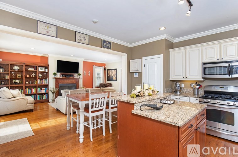 A kitchen with a table and chairs in the middle of the room.