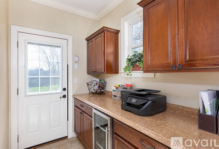 A kitchen with brown cabinets and a white door.