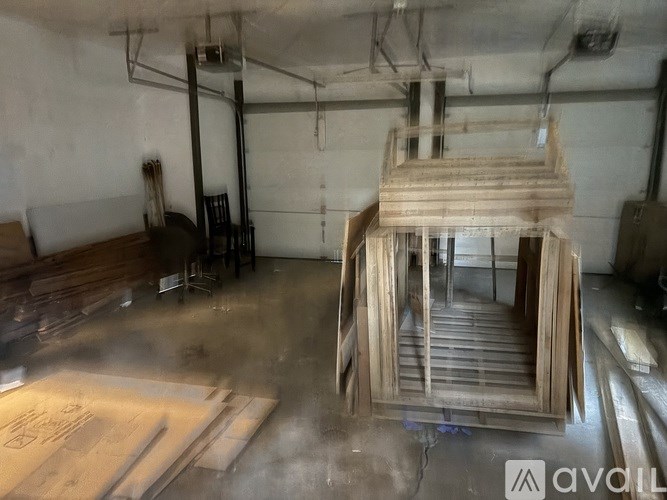 A wooden staircase is being constructed in a workshop.