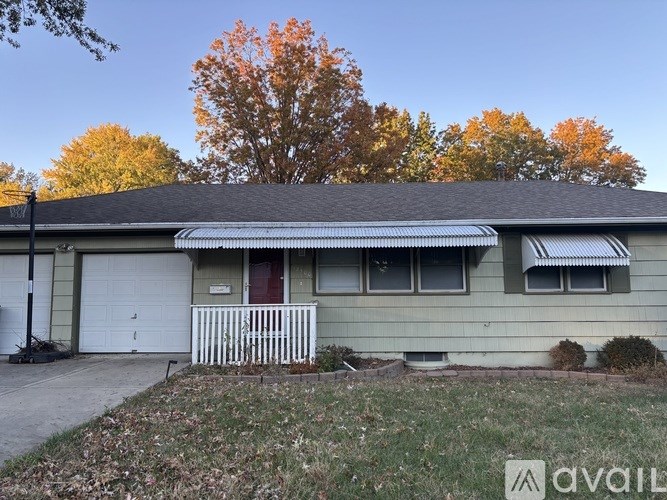 A house with a white fence in front of it.