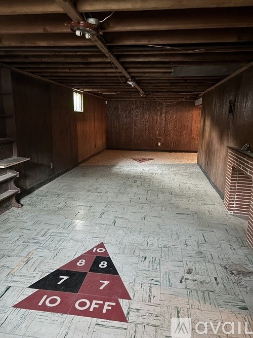 A room with a wooden floor and a rug that says "10 off" on it.