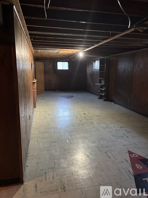 A room under construction with wooden walls and a wooden floor.