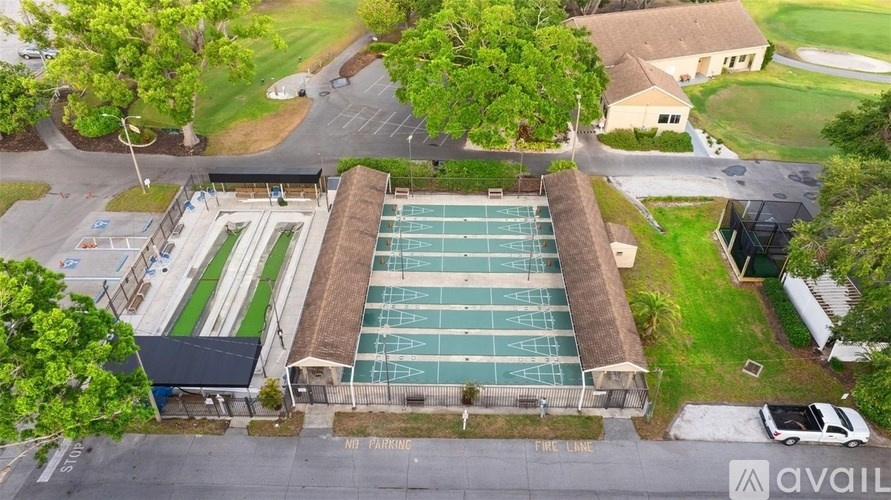 An aerial view of a parking lot with a swimming pool.