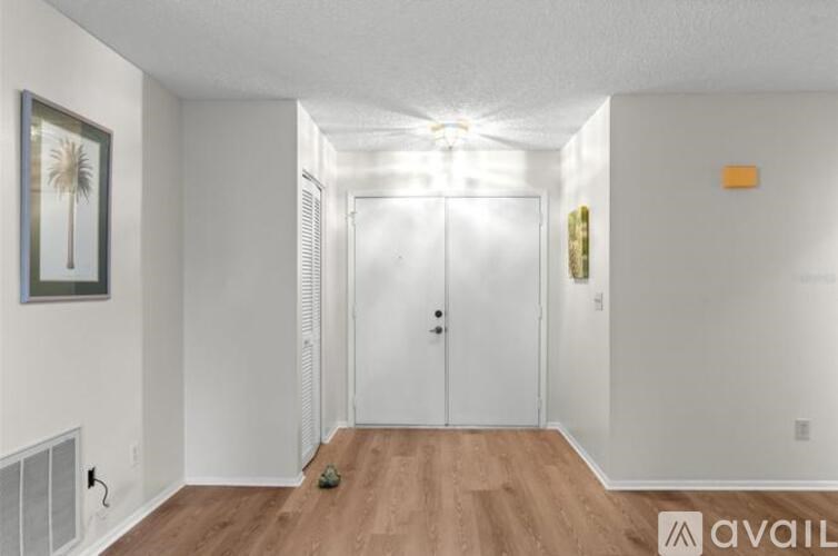 A room with a white wall and a wooden floor.