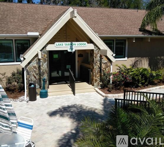 Lake Tarpon Lodge is a building with a brown roof and a sign above the entrance.