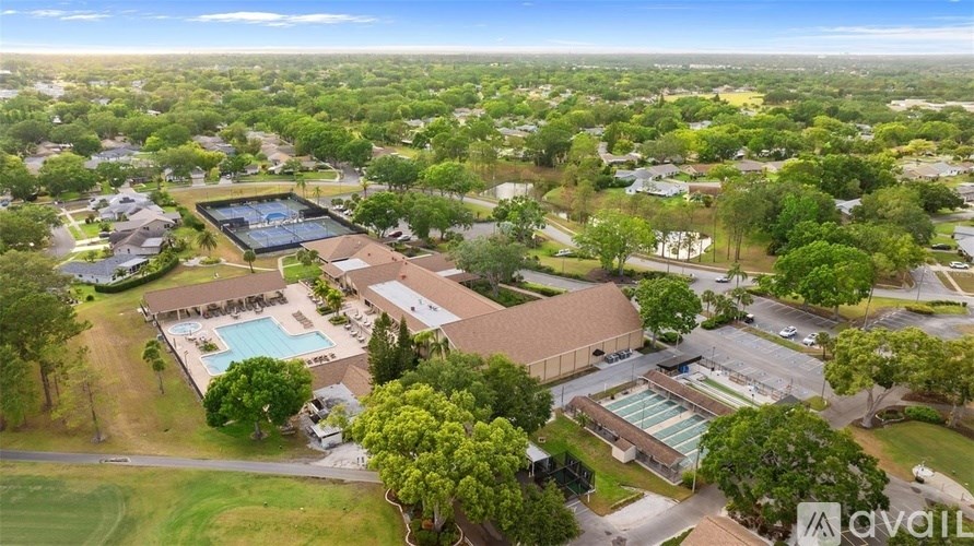 An aerial view of a school with a swimming pool and a large building.