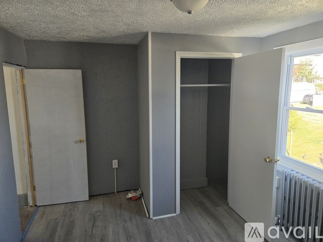 A room with a door, a wall, and a window.