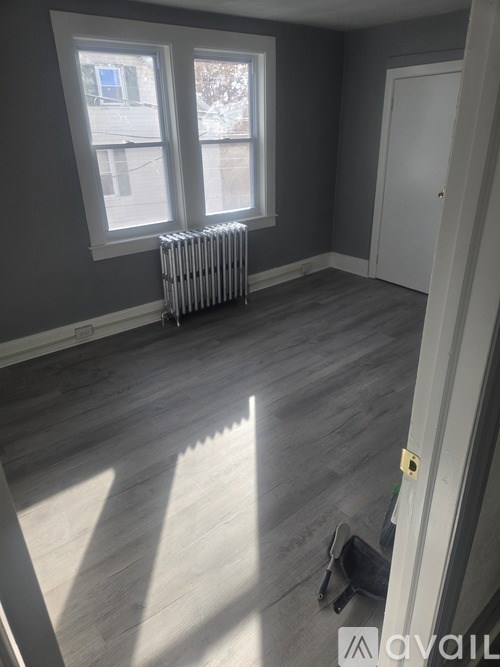 A room with grey walls and a white door.