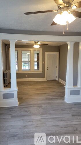 A room with a fan and a window.