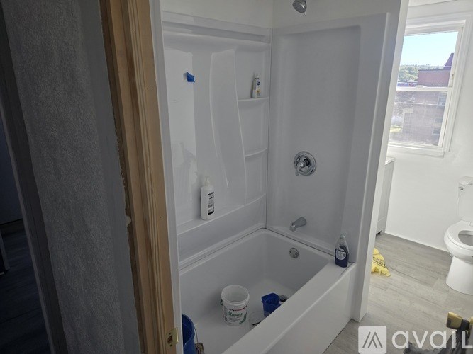 A bathroom with a tub, toilet, and sink is shown.