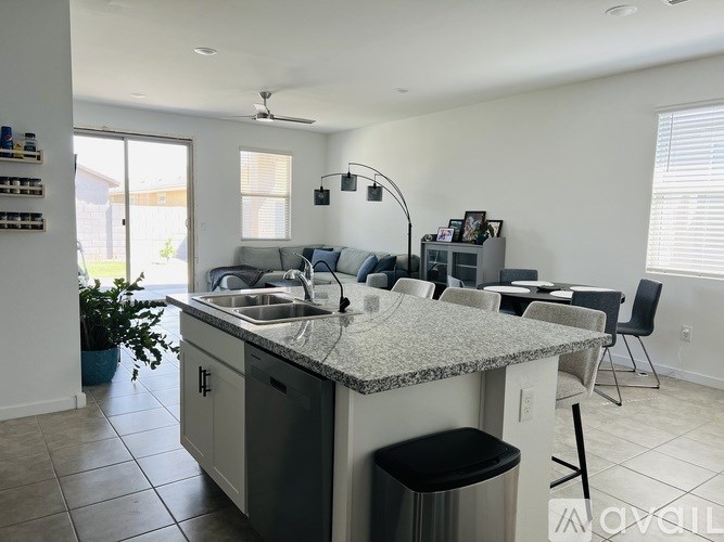 A kitchen with granite countertops and a sink.