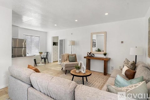 A living room with a grey sofa and a wooden coffee table.