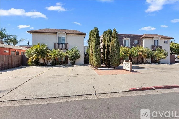 A sunny day in a residential area with houses and trees.