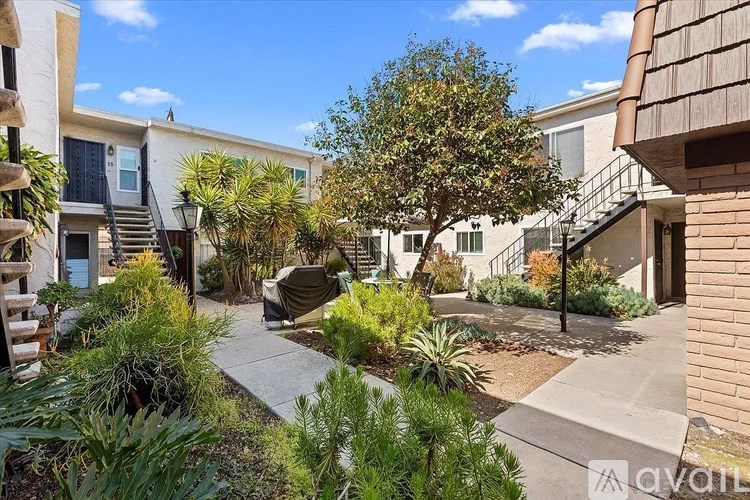 A sunny day in a courtyard surrounded by buildings.