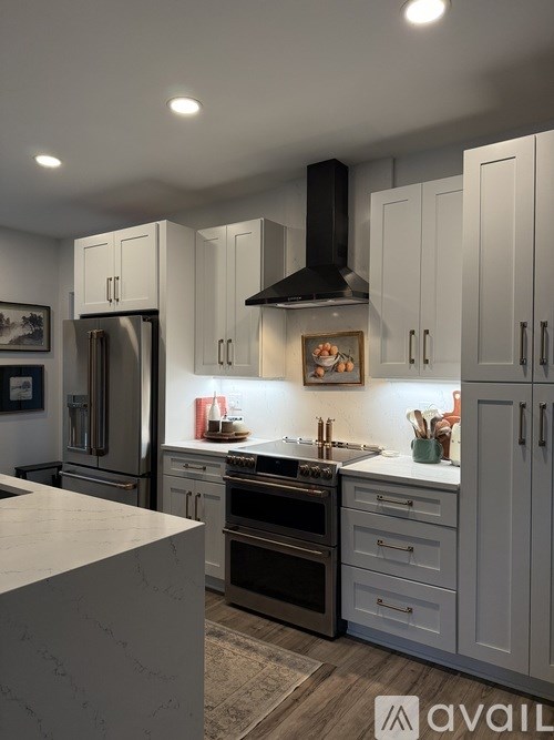A modern bathroom with a white toilet and a glass shower enclosure.
