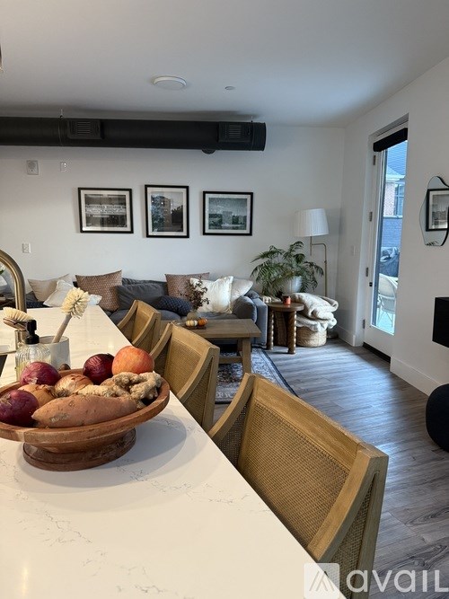 A bedroom with a large bed and a painting on the wall.