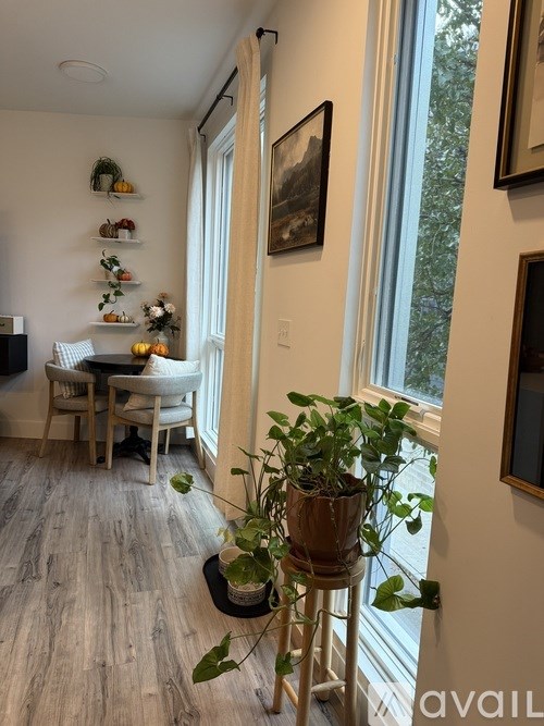 A balcony with a white couch and a red rug.