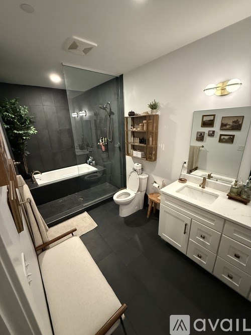 A bedroom with a bed, nightstand, and a cabinet.