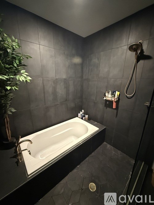 A room with a desk, chair, and a computer monitor.