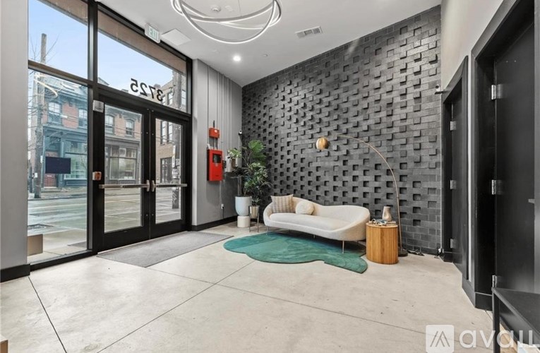 A modern living room with a black brick wall and a white sofa.