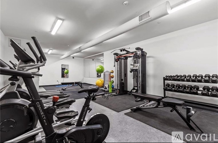 A modern hallway with a black and white artwork on the wall.