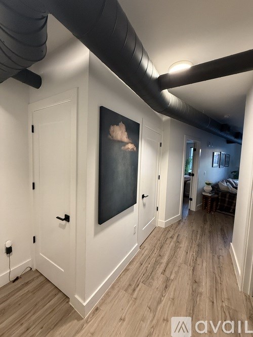 A kitchen with a black stove top oven and white cabinets.
