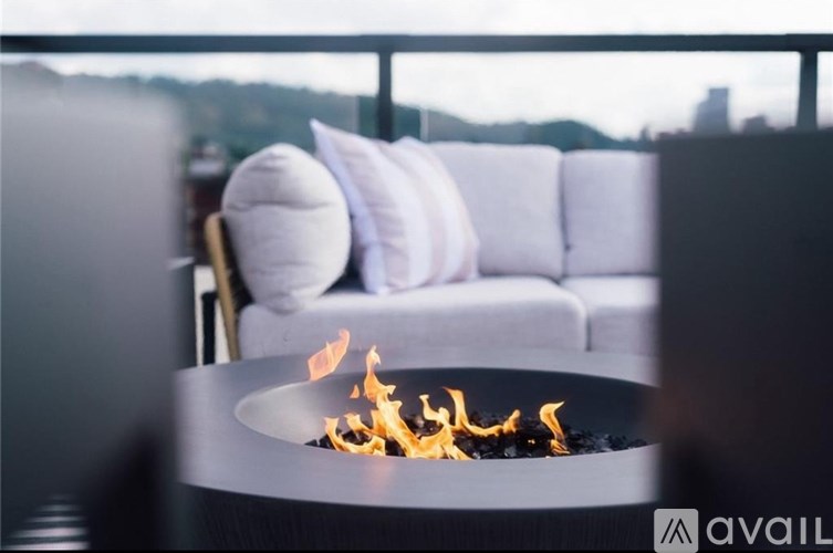 A modern fireplace with a view of the city skyline in the background.