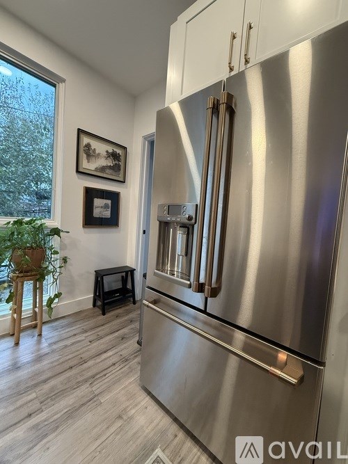 A bathroom with a white vanity and a mirror above it.
