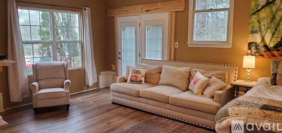 A living room with a couch, chair, and a fireplace.
