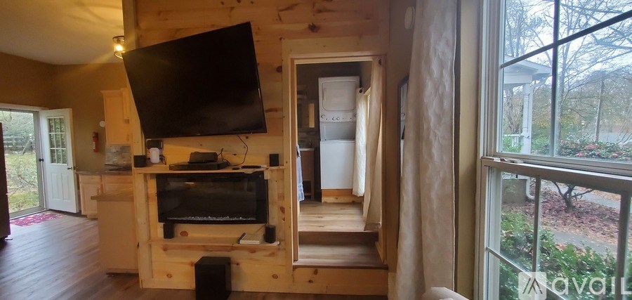 A living room with a television and a fireplace.